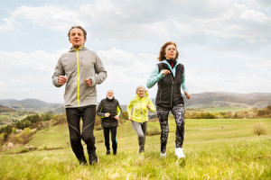 82729346 - group of seniors running outside on green hills.