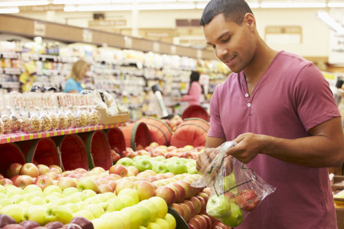 42270308 - man at fruit counter in supermarket