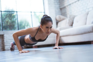Asian women exercise indoor at home she is acted "push up"